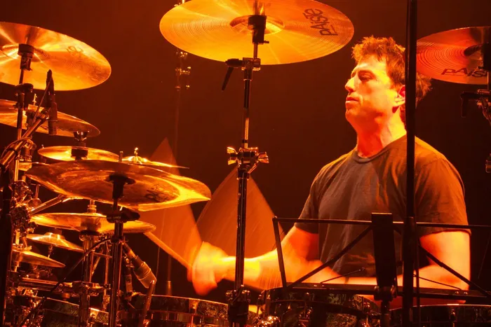 Steve Joslin behind a large drum kit mid-performance