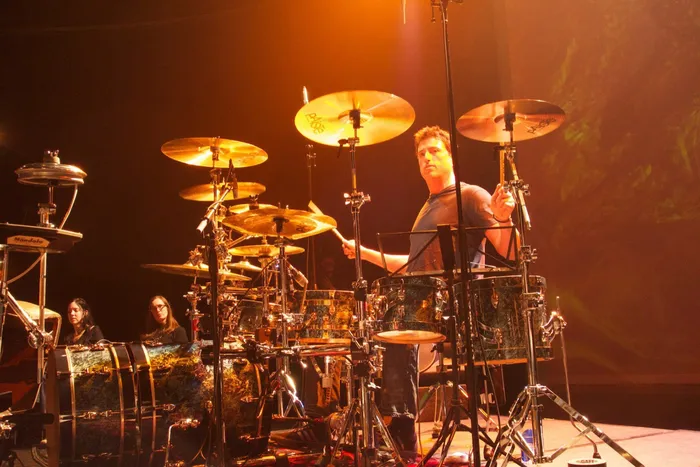 Steve Joslin drumming with cymbals in the foreground